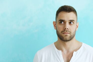 Man looking away from camera on blue background