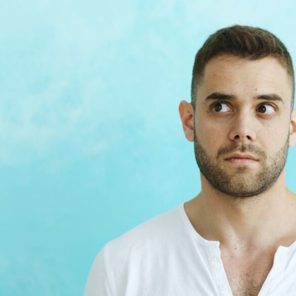 Man looking away from camera on blue background